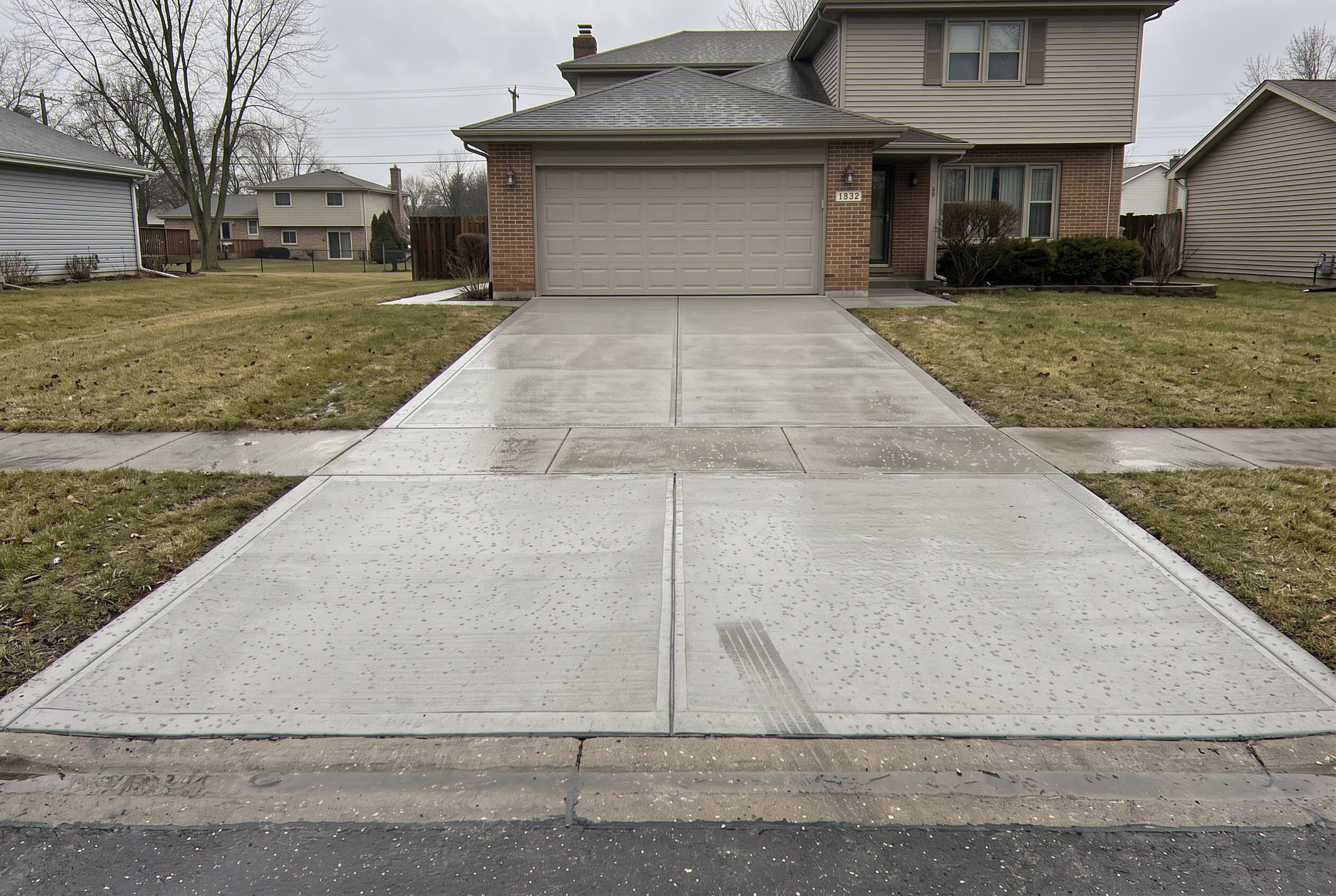 Finished two-car concrete driveway leading to the garage