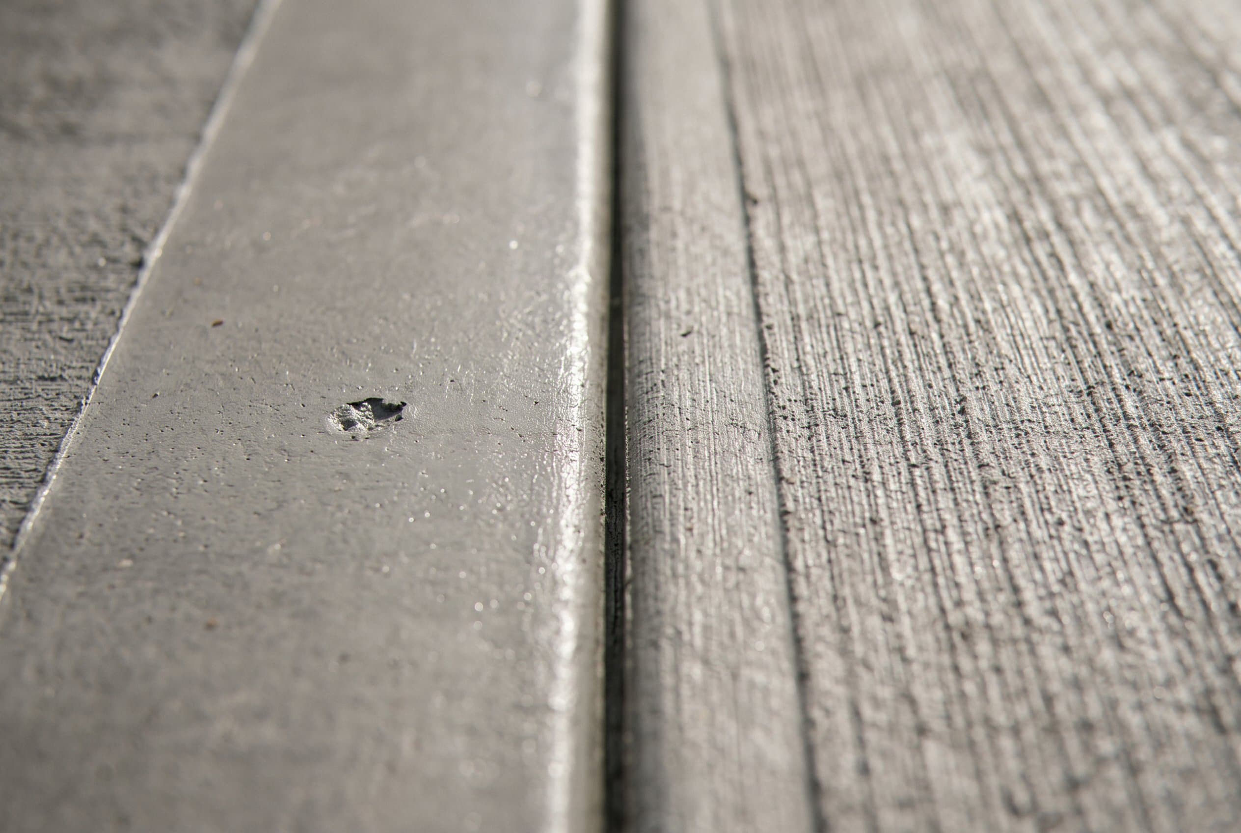 Close-up of a concrete patio control joint