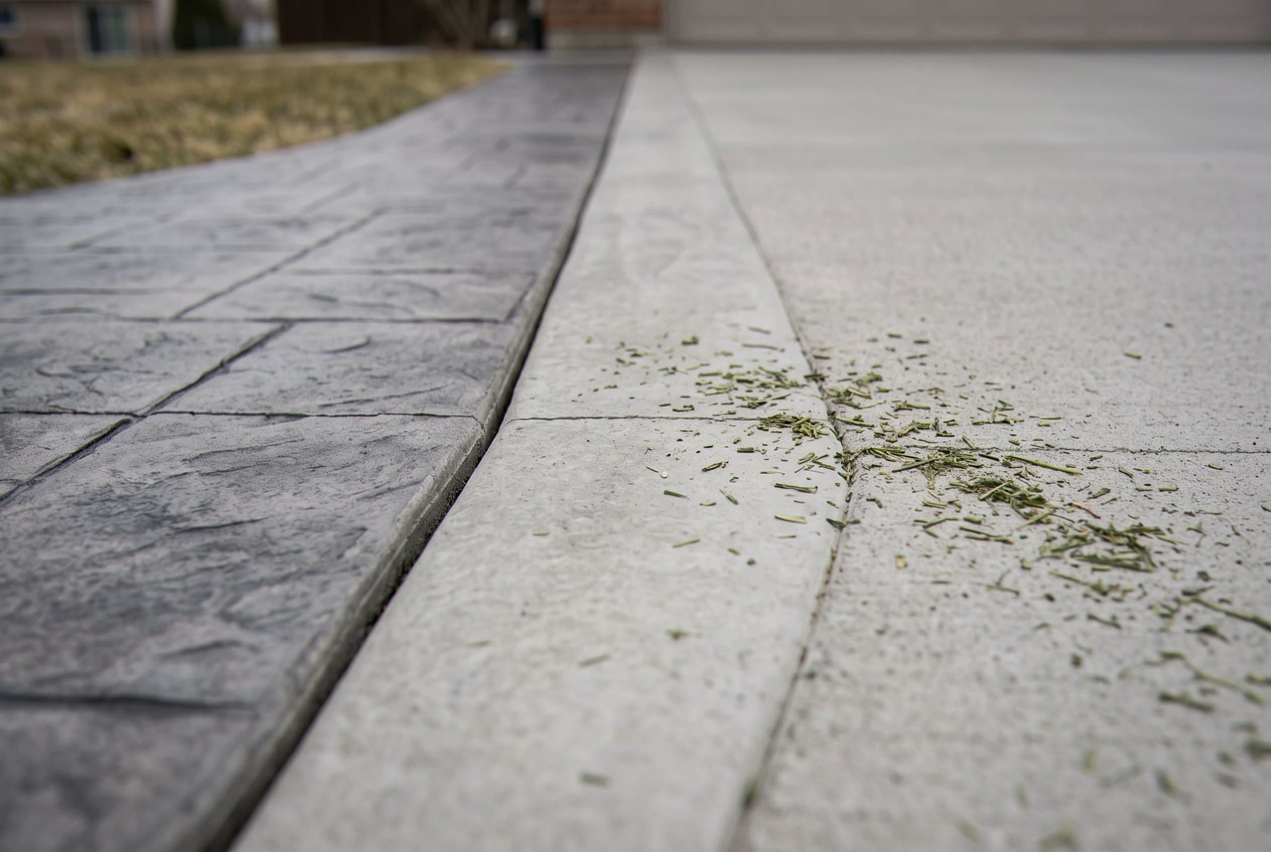 Edge where stamped stone pattern meets plain concrete